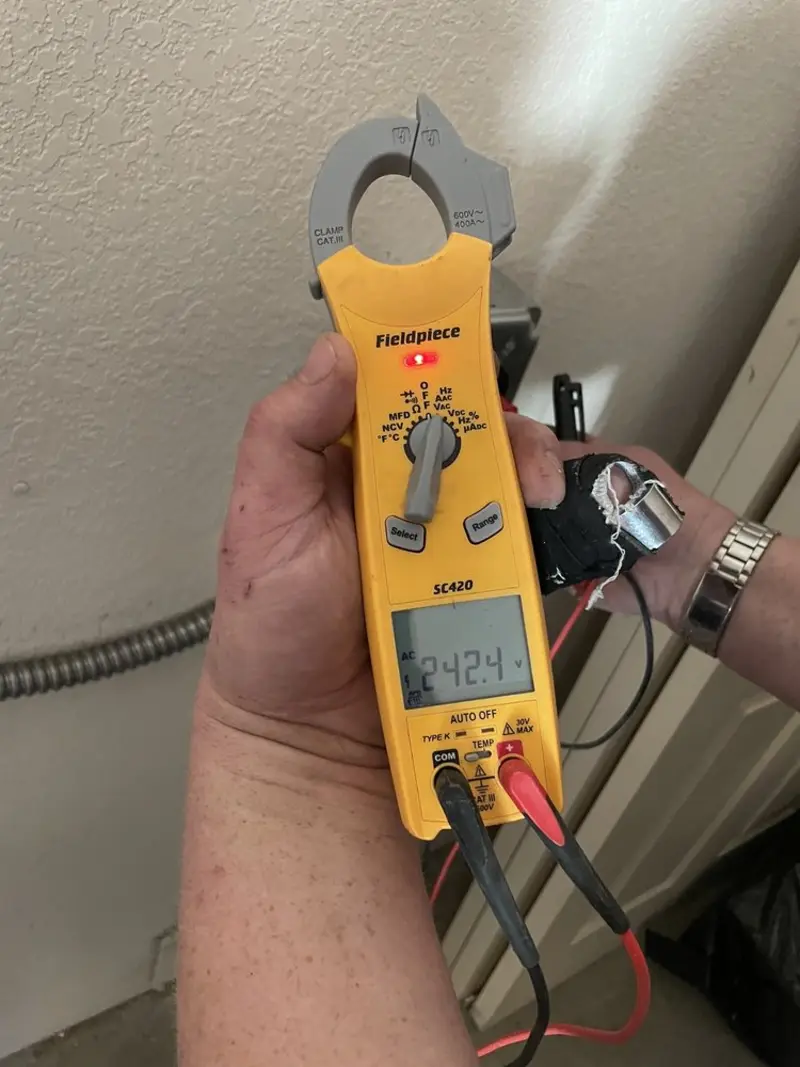 Voltage testing with clamp meter during Ceiling Fan Installation in Savannah